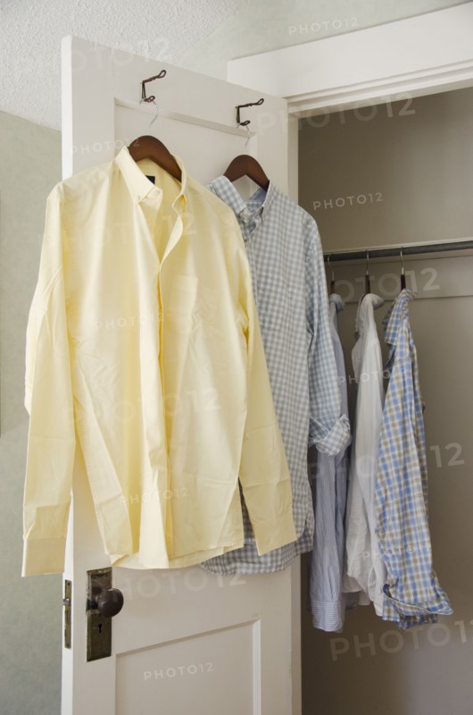 Button down shirts hanging on cloth hangers