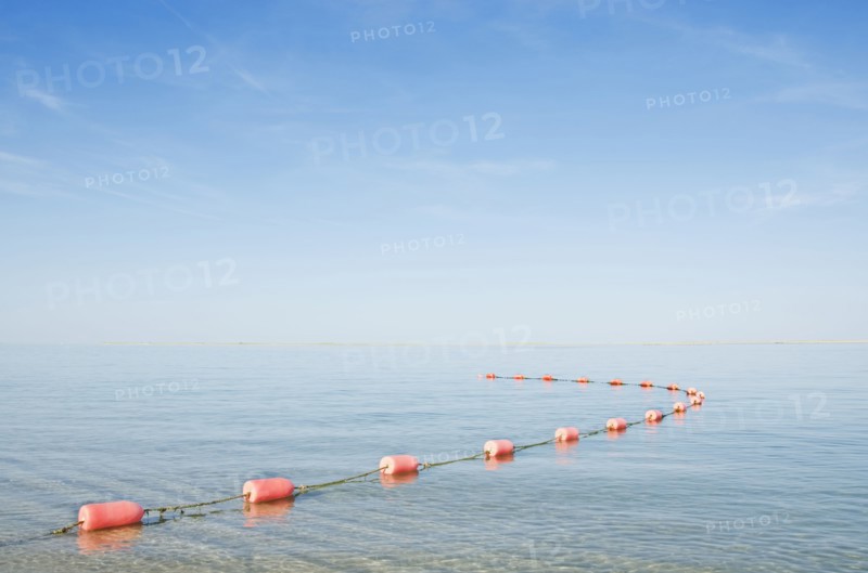 Rope with buoys on calm sea