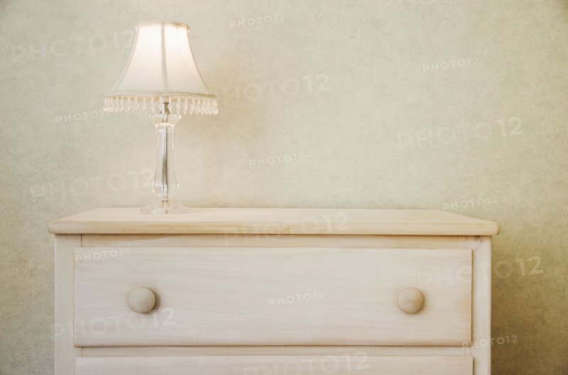 Electric lamp on wooden dresser