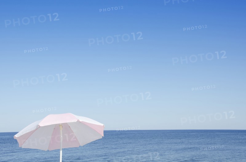 Sunshade against blue seascape