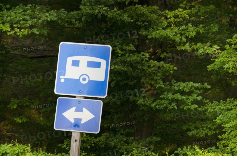 Blue road sign with forest in background
