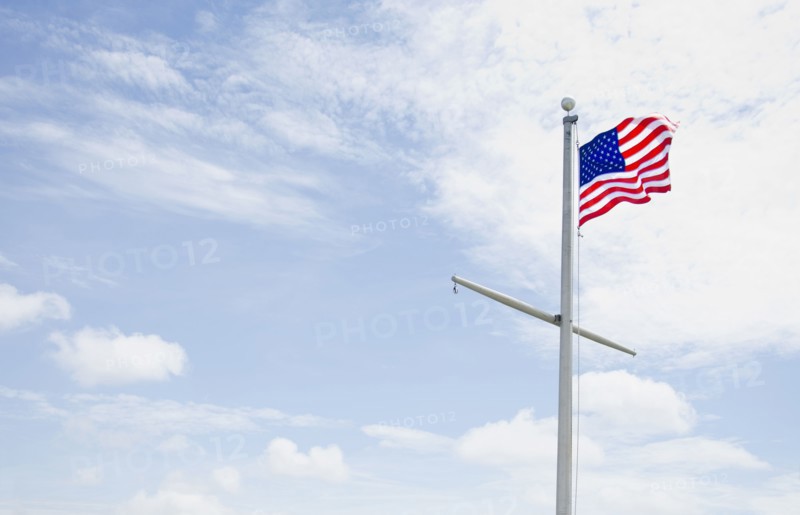 American flag against cloudy sky