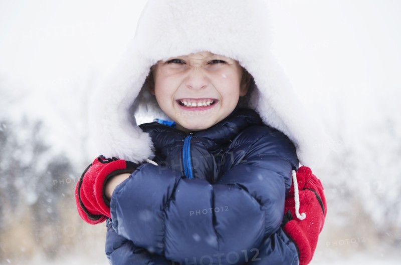 Portrait of boy (6-7) in fur hat and gloves