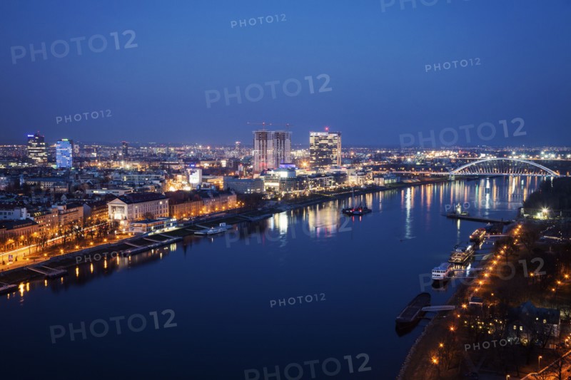 Illuminated cityscape and river at night