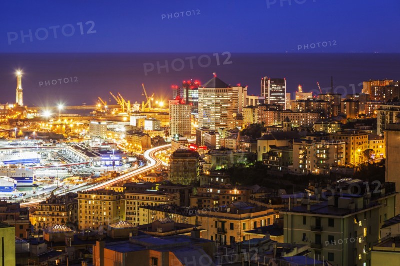 Cityscape with harbor in background at night