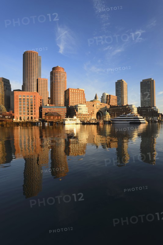 City waterfront reflected in harbor