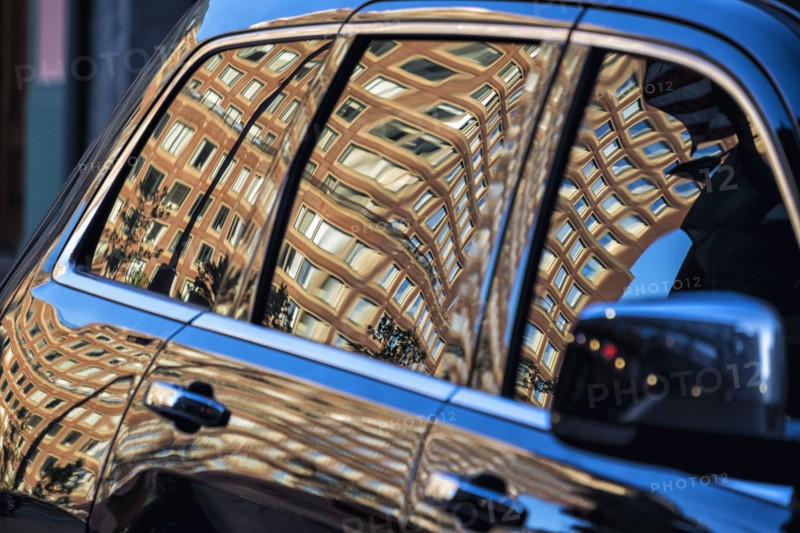 Building reflected in car