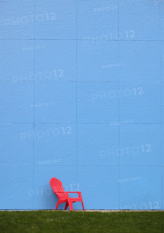 Red chair by blue wall