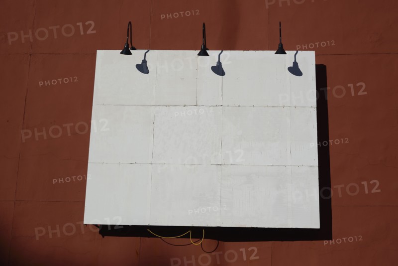 White billboard on red wall