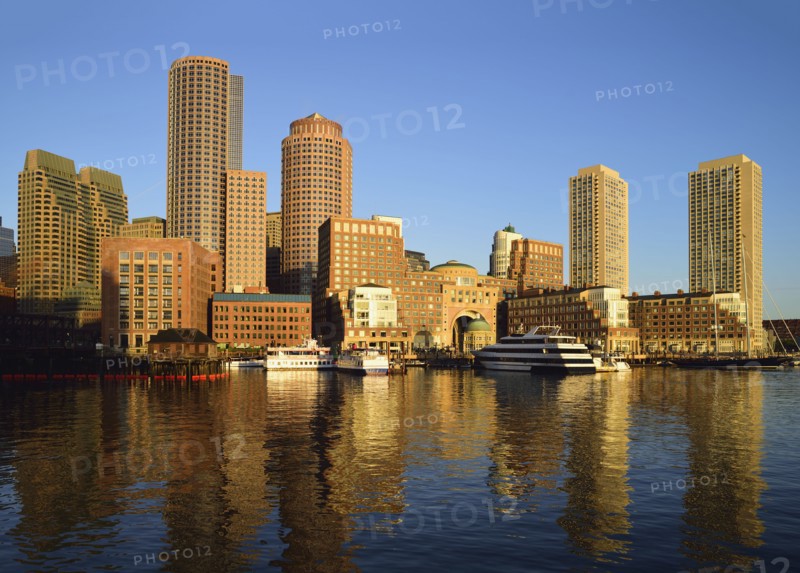 City waterfront reflected in harbor