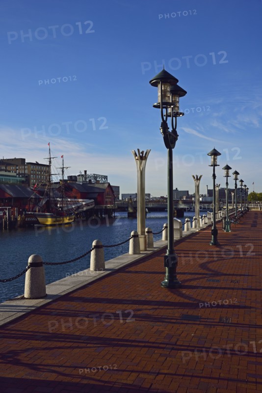 Pedestrian walkway at waterfront in sunlight