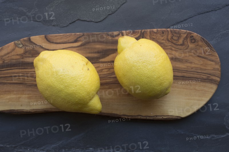 Two lemons on wood board