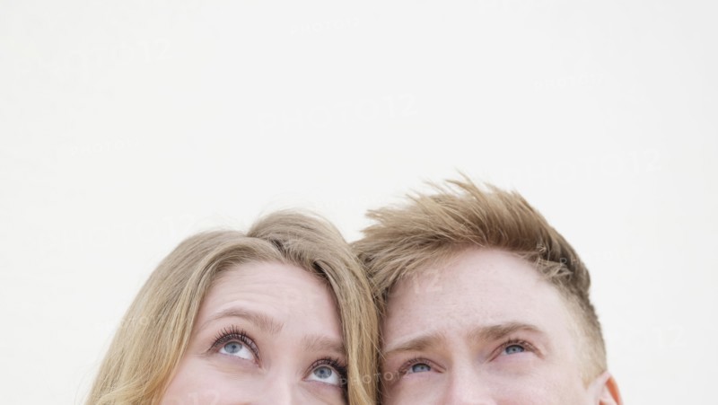 Young couple looking up.