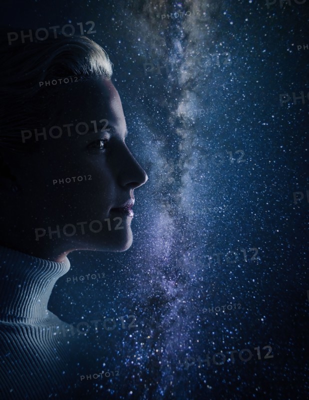 Studio shot of young woman looking at stars.
