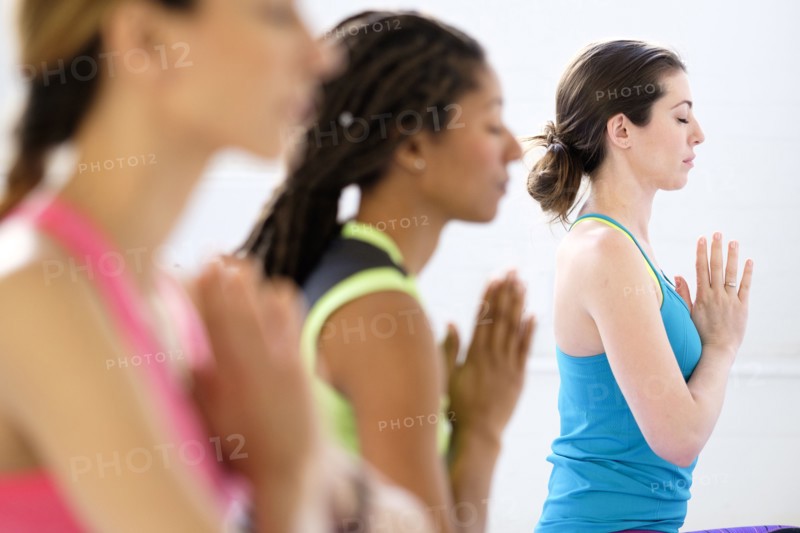 Women in lotus position meditating.
