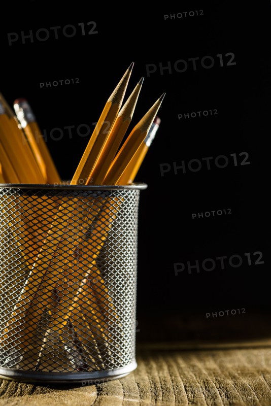 Sharp pencils in metal container.