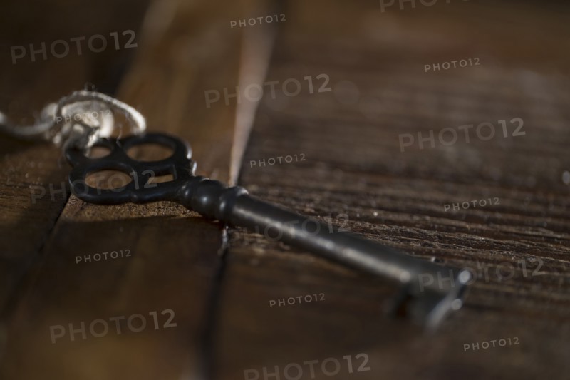 Skeleton key on wooden table.