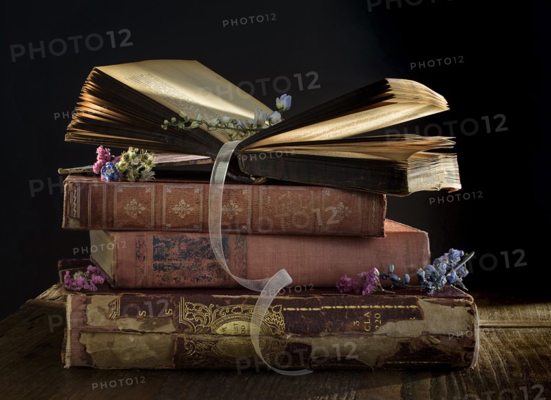 Stack of old books on table.