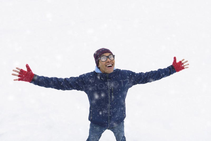 Mid adult man standing on snow.