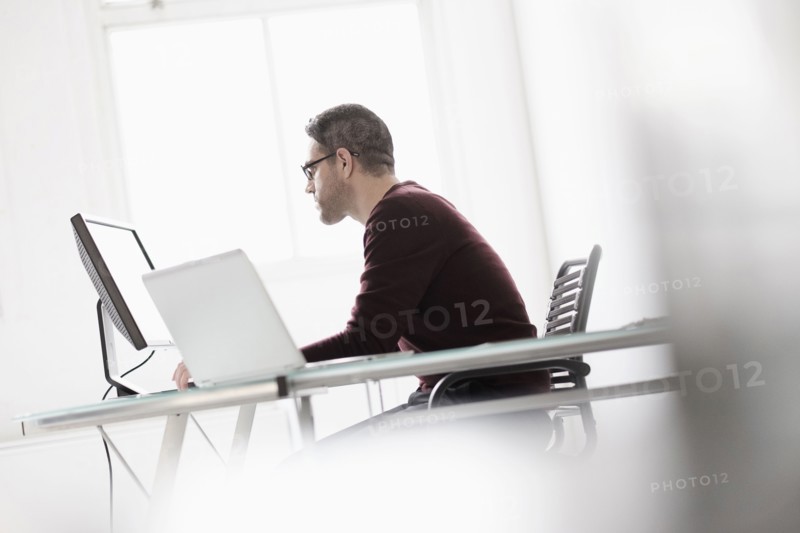 Man using computer in office.