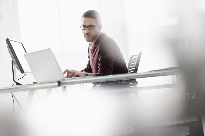 Man using laptop in office.