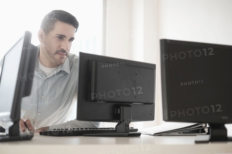 Man using computer in office.