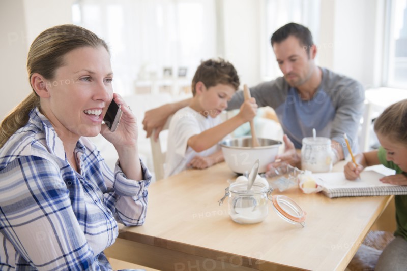Family with two children (6-7, 8-9) sitting at table