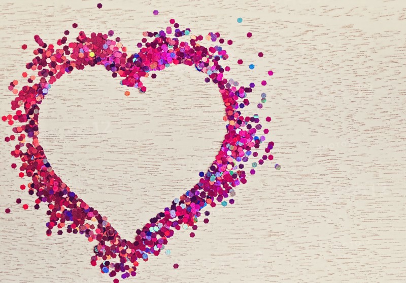 Confetti in shape of heart on wood
