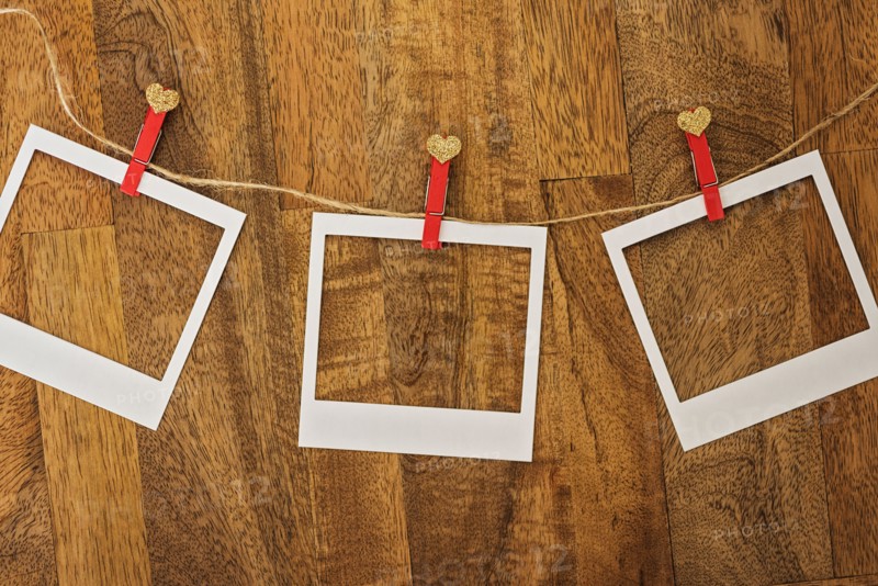 Empty Polaroid frames in a row on wood
