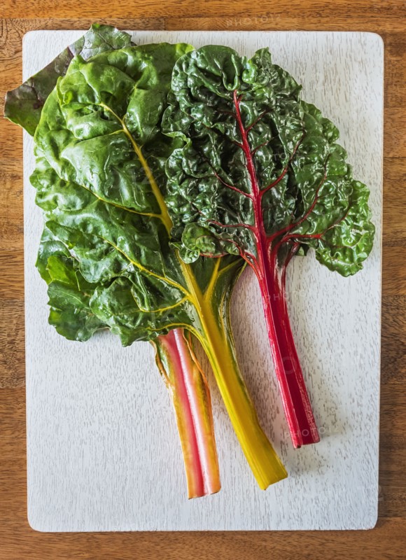 Rainbow chard leaves on cutting board