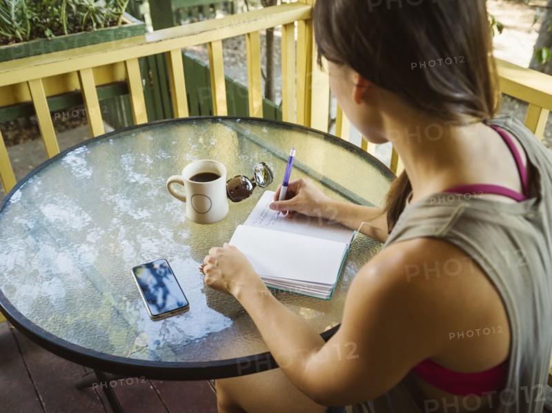 Young woman writing in diary
