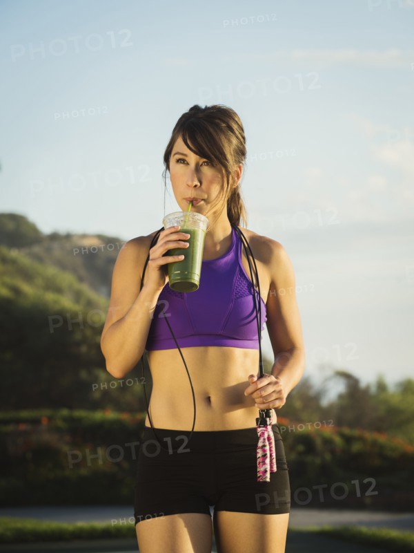 Young woman drinking smoothie