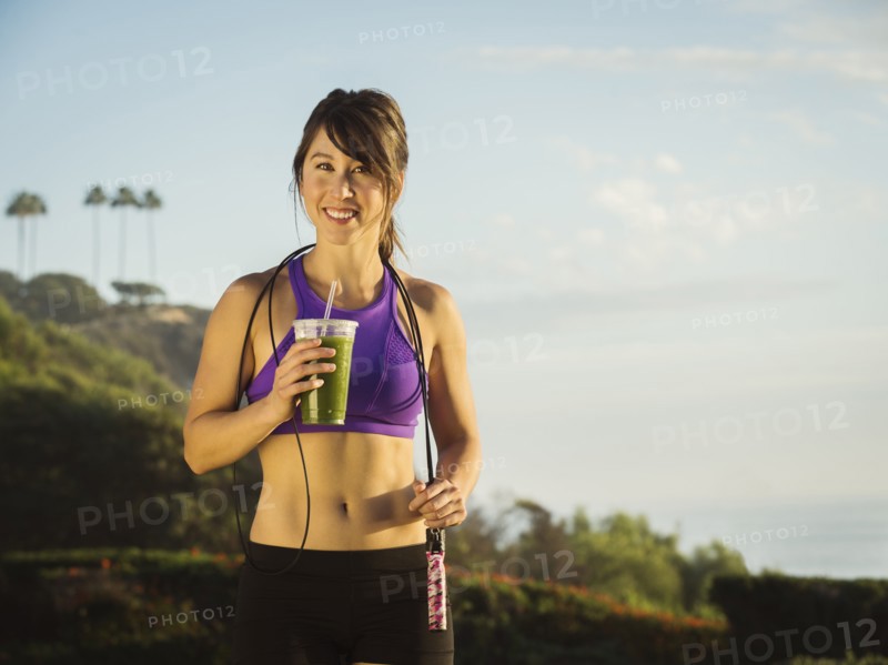 Young woman holding smoothie