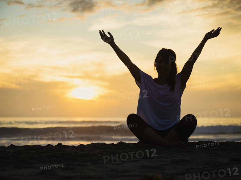 Young woman sitting on beach