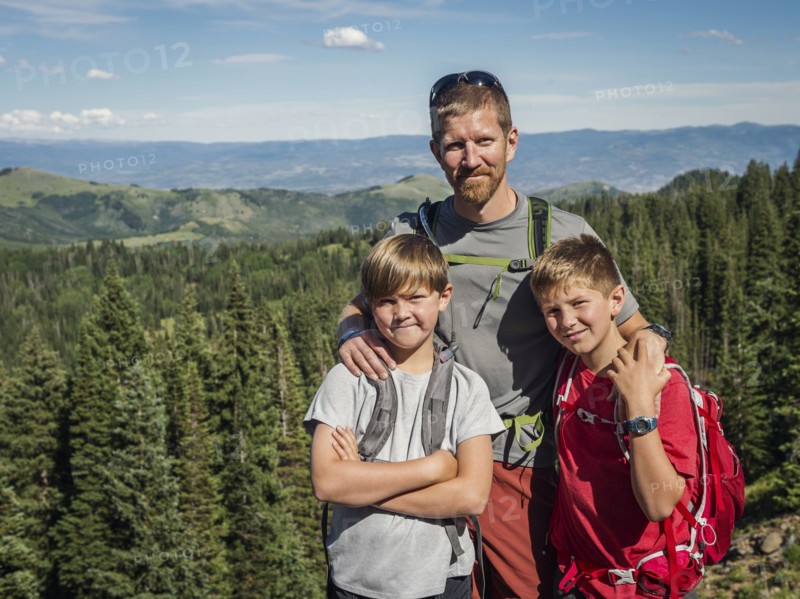 Father and sons (10-11, 12-13) outdoors