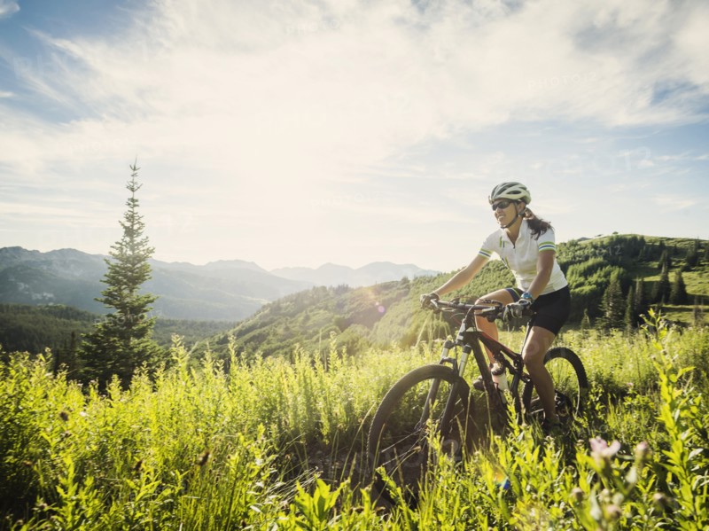 Woman during bicycle trip in mountain scenery