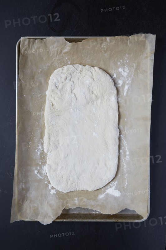 Pizza dough on wax paper