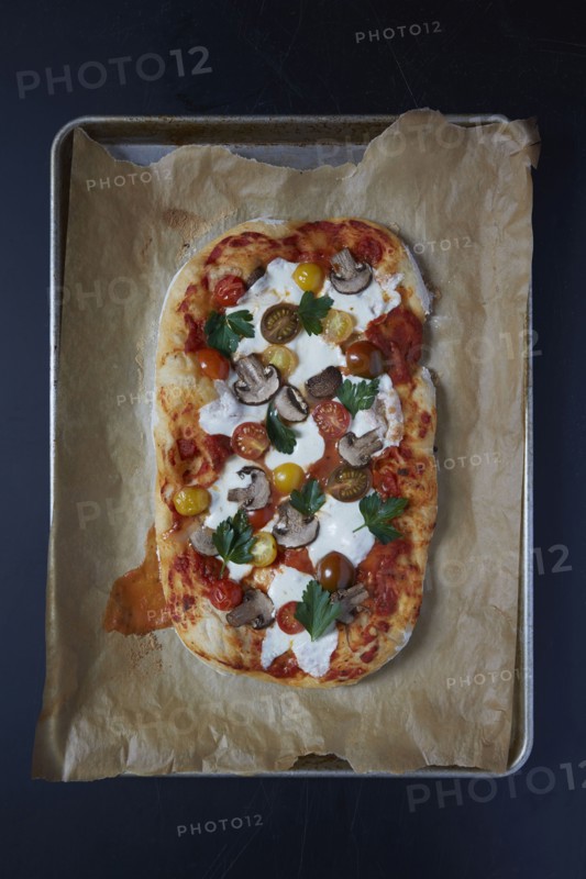 Baked pizza on wax paper