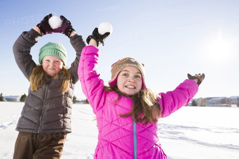 Girls (8-9, 10-11) playing with snowballs