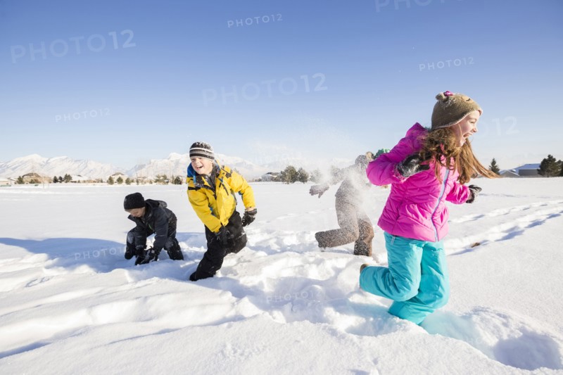Children (8-9, 10-11) playing in snow
