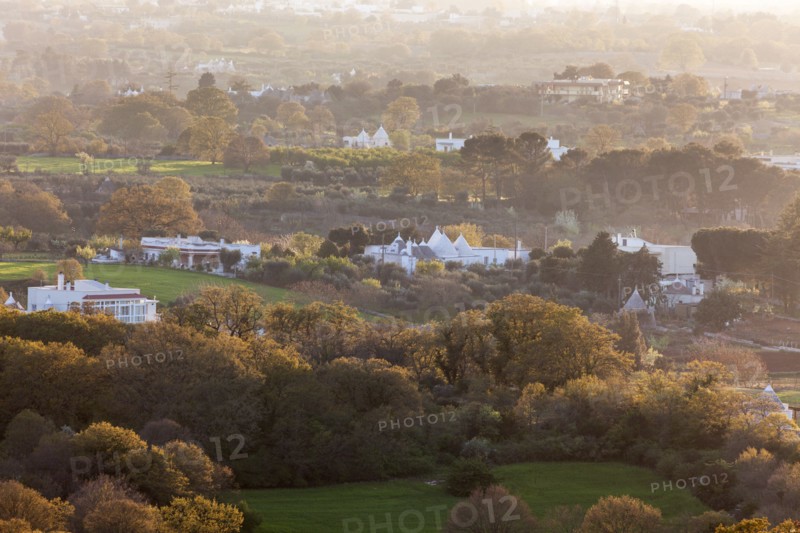 Landscape with trulli houses at sunset