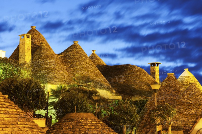 Traditional roofs of trulli houses at sunset