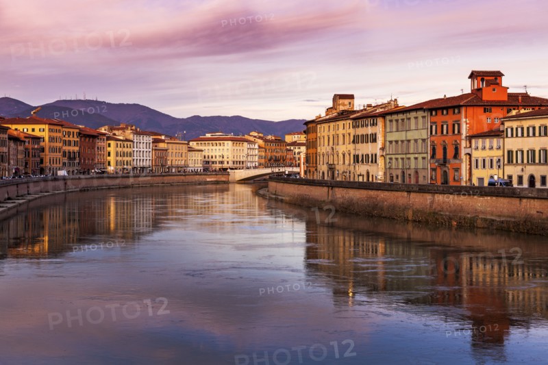 Townhouses by Arno river at sunset