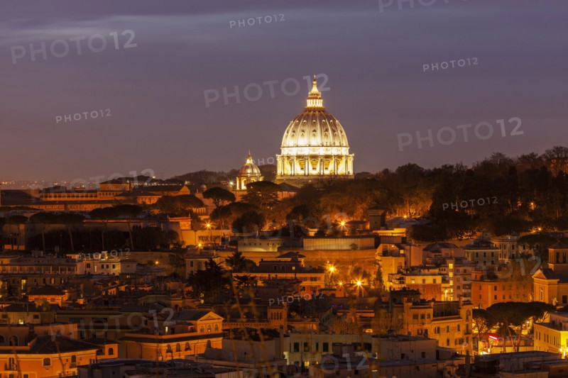 Illuminated St. Peter's Basilica at dusk