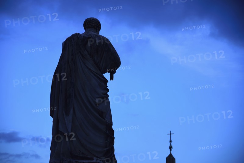 Statue of St. Peter against sky at dusk