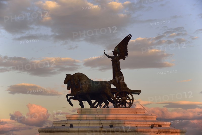 Statue of goddess Victoria on Altare della Patria at sunset