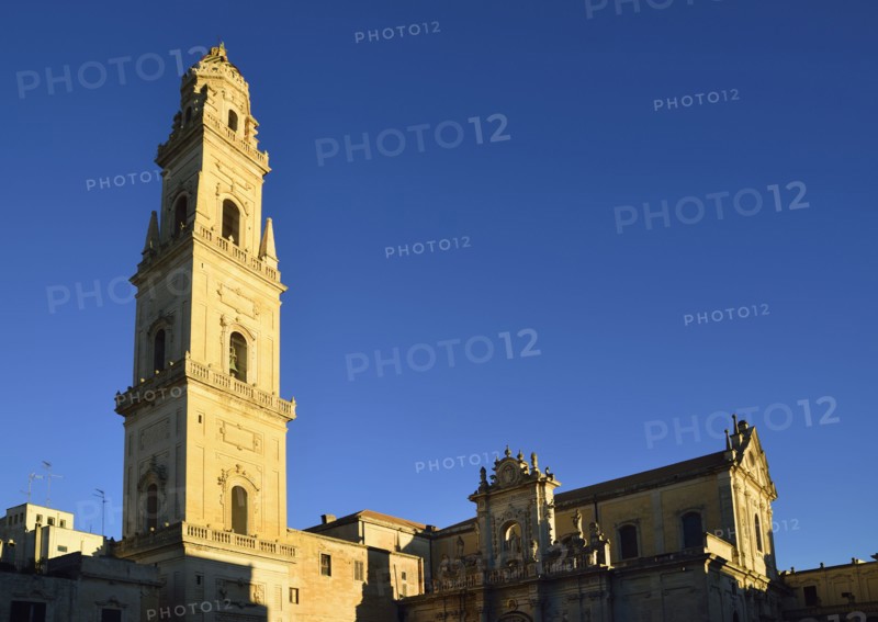 Bell tower and cathedral against clear sky