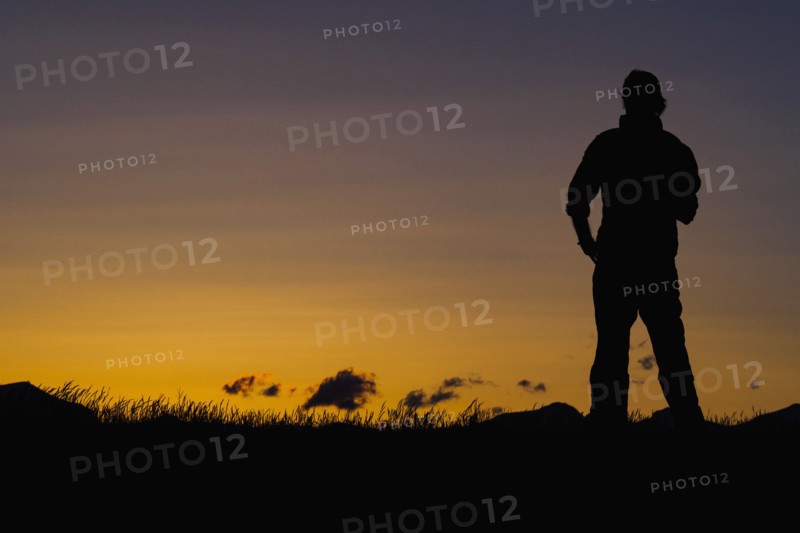 Silhouette of man standing at dusk