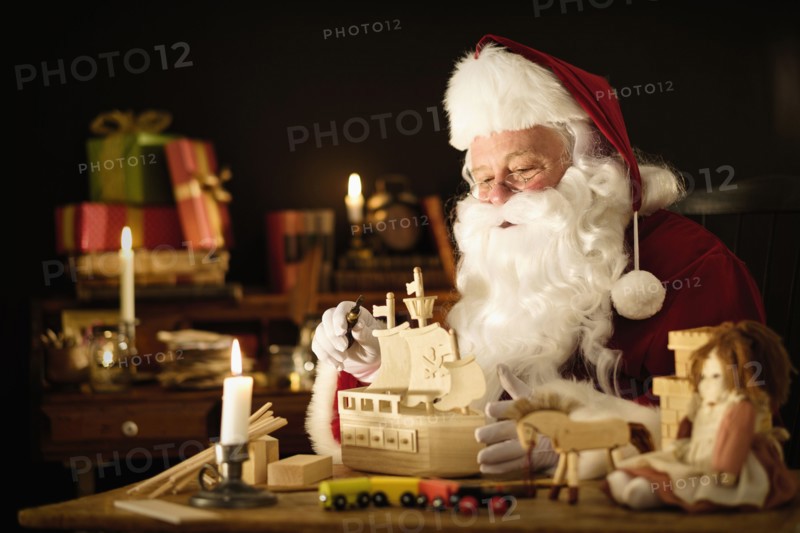 Santa Claus making wooden toy.