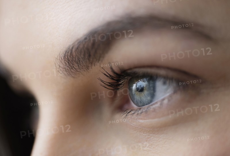Close up of young woman with blue eyes.